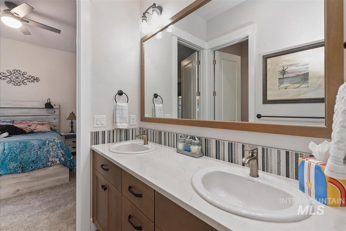 3413 North Hosta Avenue Star, ID 83669 - Photo 22 of 50 Bathroom featuring connected bathroom, double vanity, and a ceiling fan