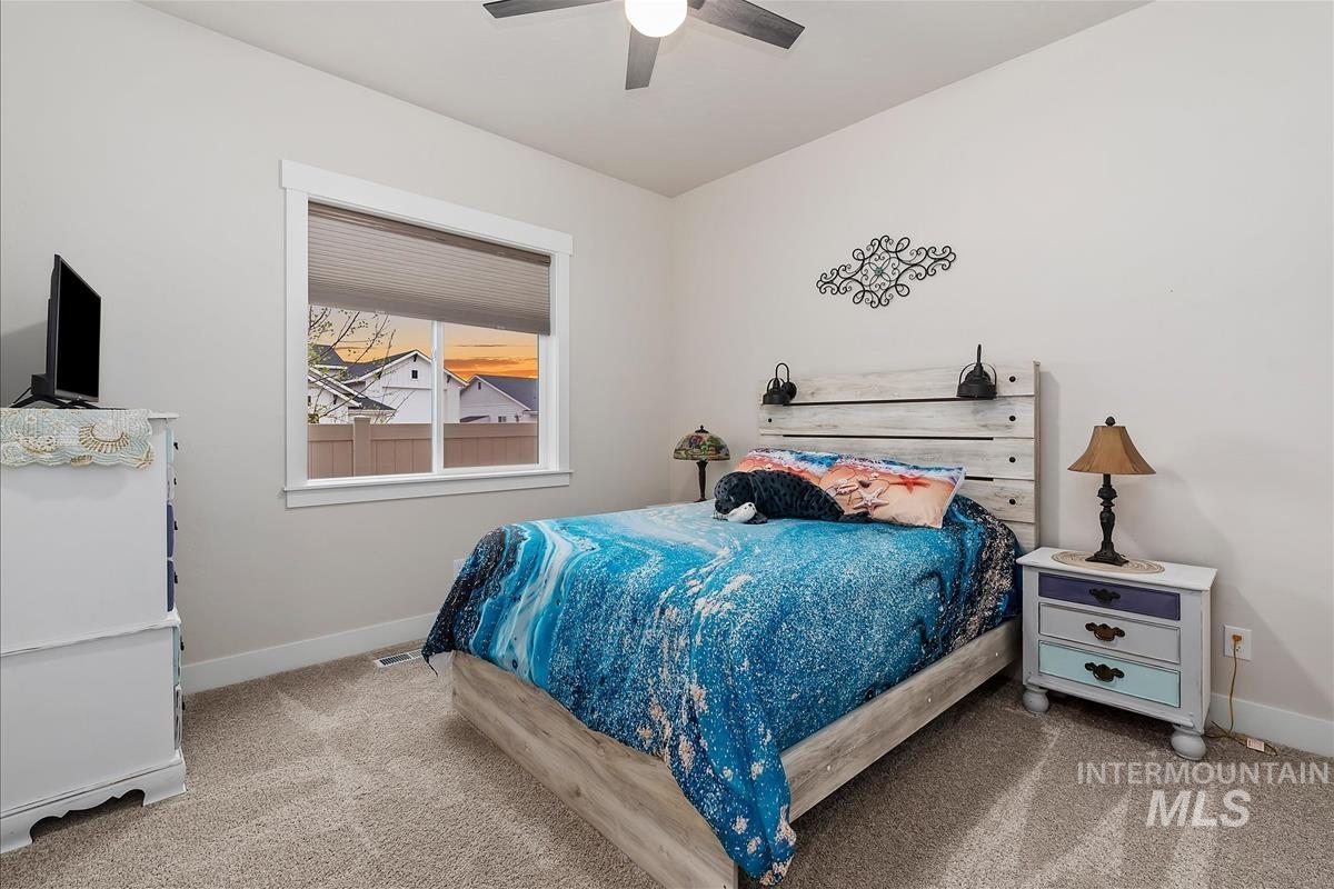 3413 North Hosta Avenue Star, ID 83669 - Photo 23 of 50 Bedroom with light colored carpet and ceiling fan