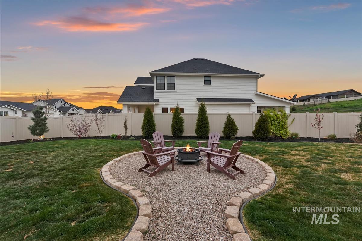 3413 North Hosta Avenue Star, ID 83669 - Photo 30 of 50 Rear view of property featuring a fire pit, a patio area, and a fenced backyard