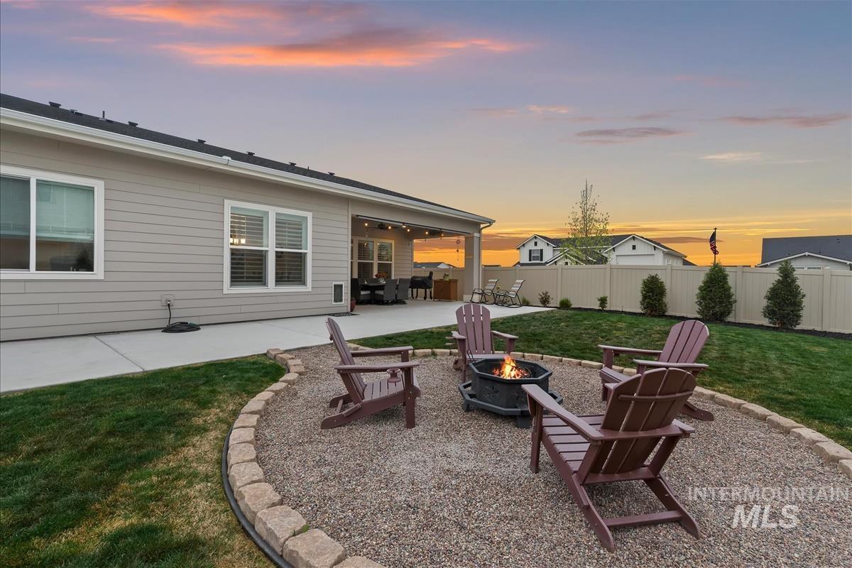 3413 North Hosta Avenue Star, ID 83669 - Photo 33 of 50 Patio terrace at dusk featuring a patio, an outdoor fire pit, and a fenced backyard
