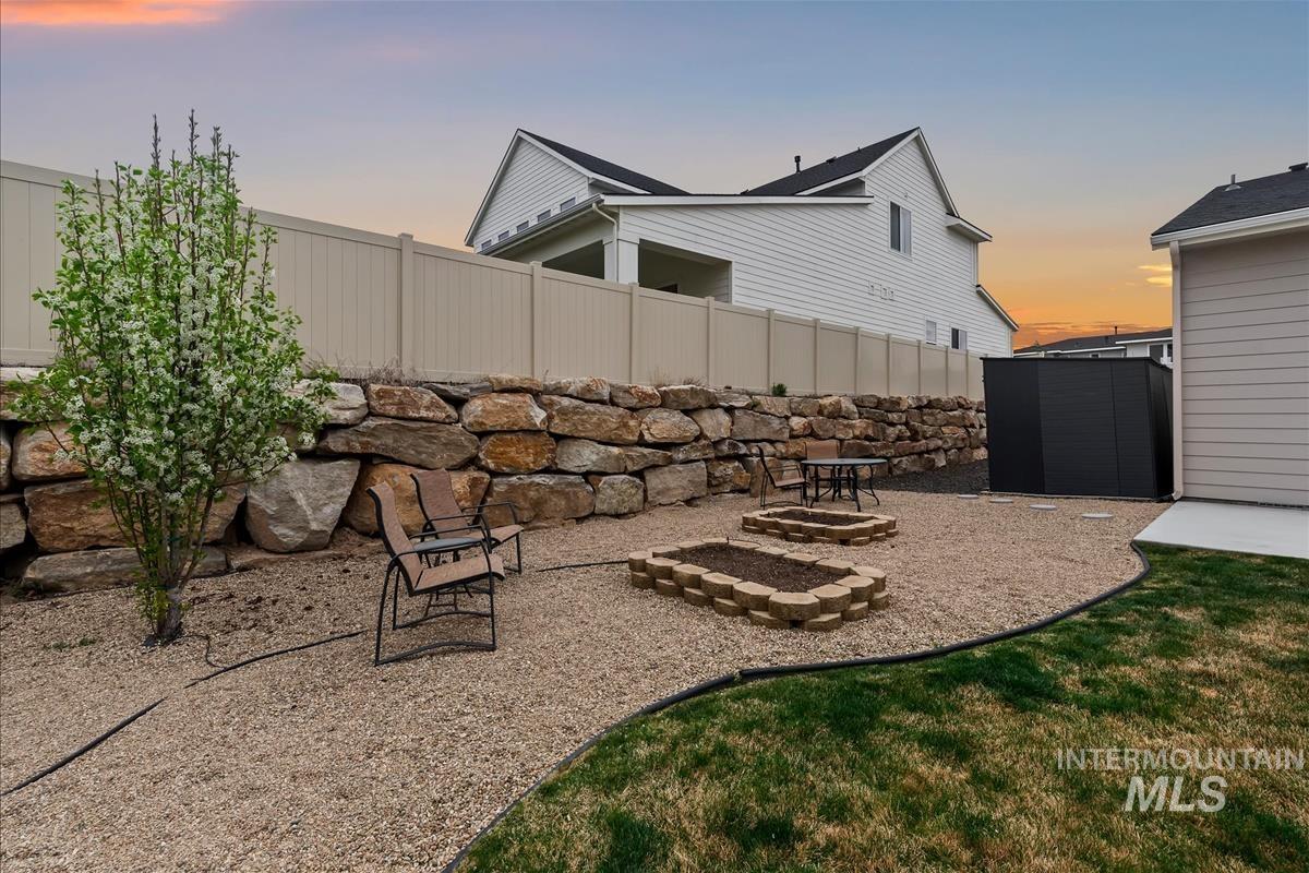 3413 North Hosta Avenue Star, ID 83669 - Photo 34 of 50 Fenced backyard with a patio area, an outdoor fire pit, and a storage shed