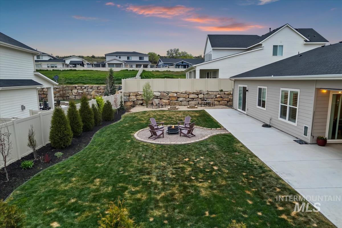3413 North Hosta Avenue Star, ID 83669 - Photo 36 of 50 Fenced backyard with a patio area and a fire pit