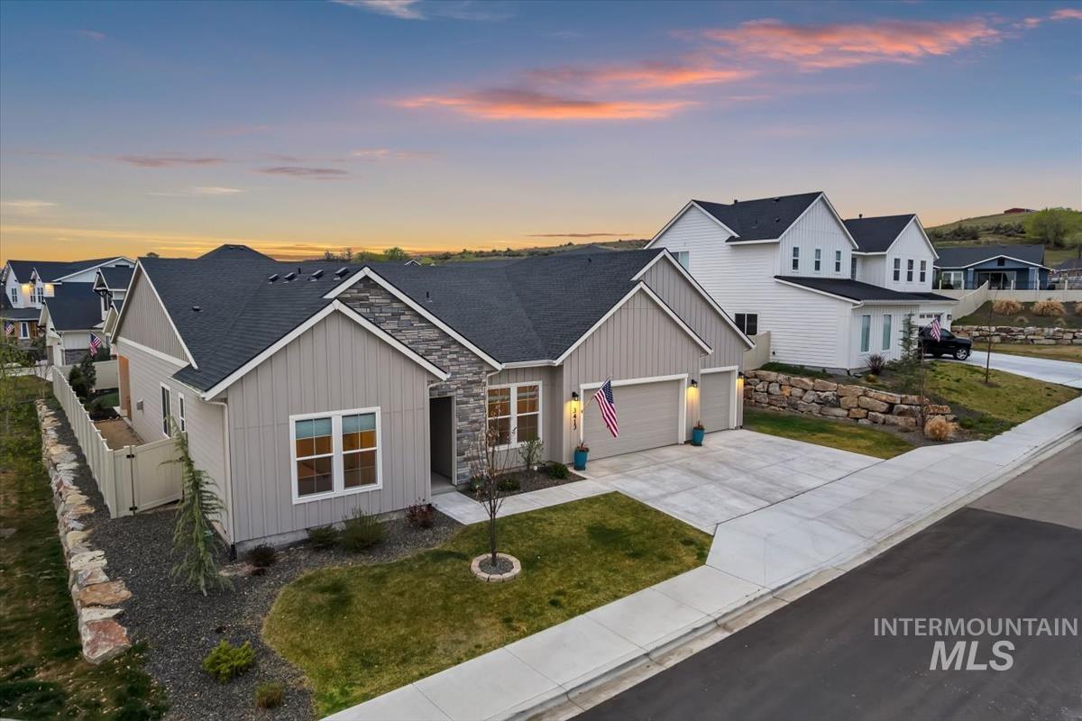 3413 North Hosta Avenue Star, ID 83669 - Photo 40 of 50 View of front of home featuring roof with shingles, driveway, a garage, and stone siding