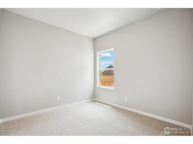 a view of an empty room and a window