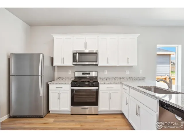 a kitchen with a refrigerator stove and sink