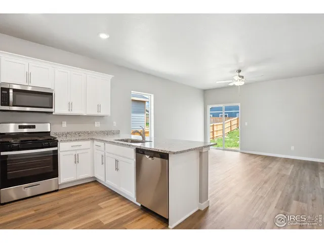 a kitchen with granite countertop a sink and appliances