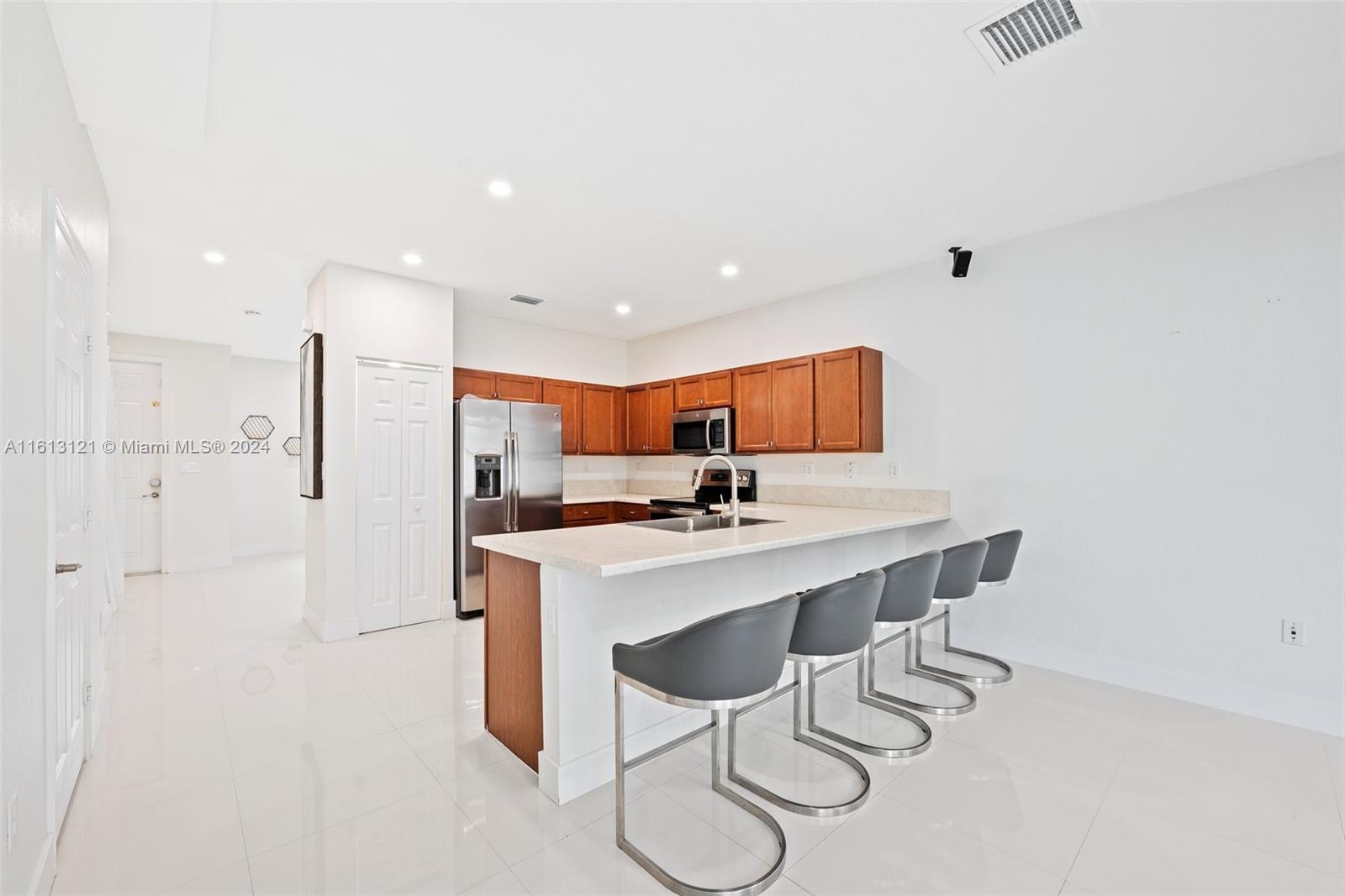 9361 West 33rd Way Hialeah, FL 33018 - Photo 11 of 30 a kitchen with a sink cabinets and wooden floor
