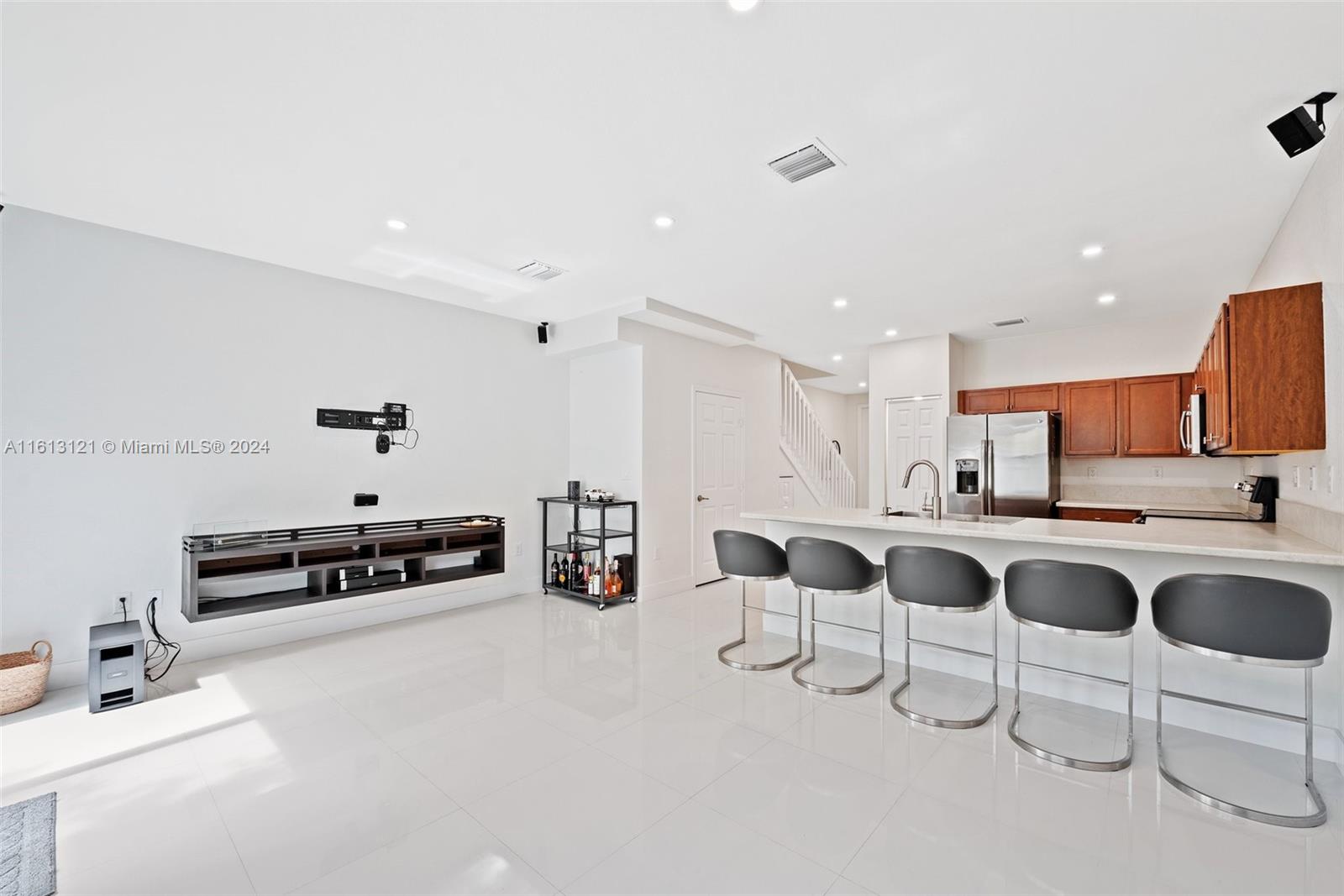 9361 West 33rd Way Hialeah, FL 33018 - Photo 12 of 30 a kitchen with stainless steel appliances kitchen island granite countertop a sink and cabinets