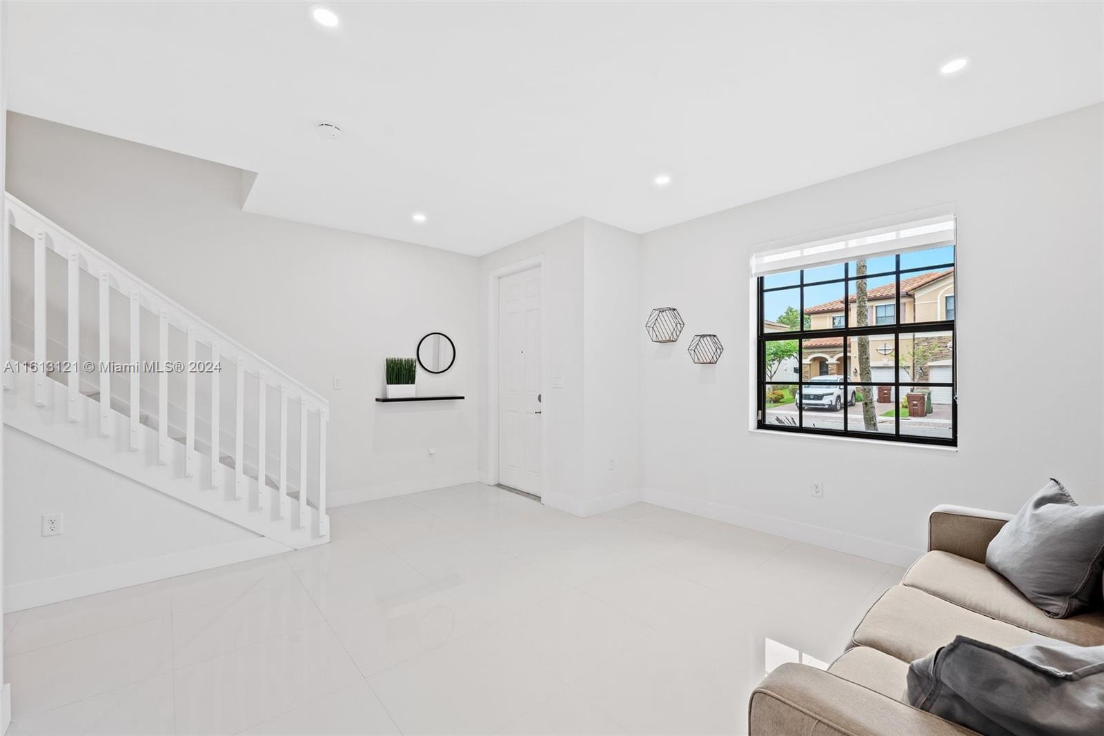 9361 West 33rd Way Hialeah, FL 33018 - Photo 3 of 30 a living room with furniture and windows
