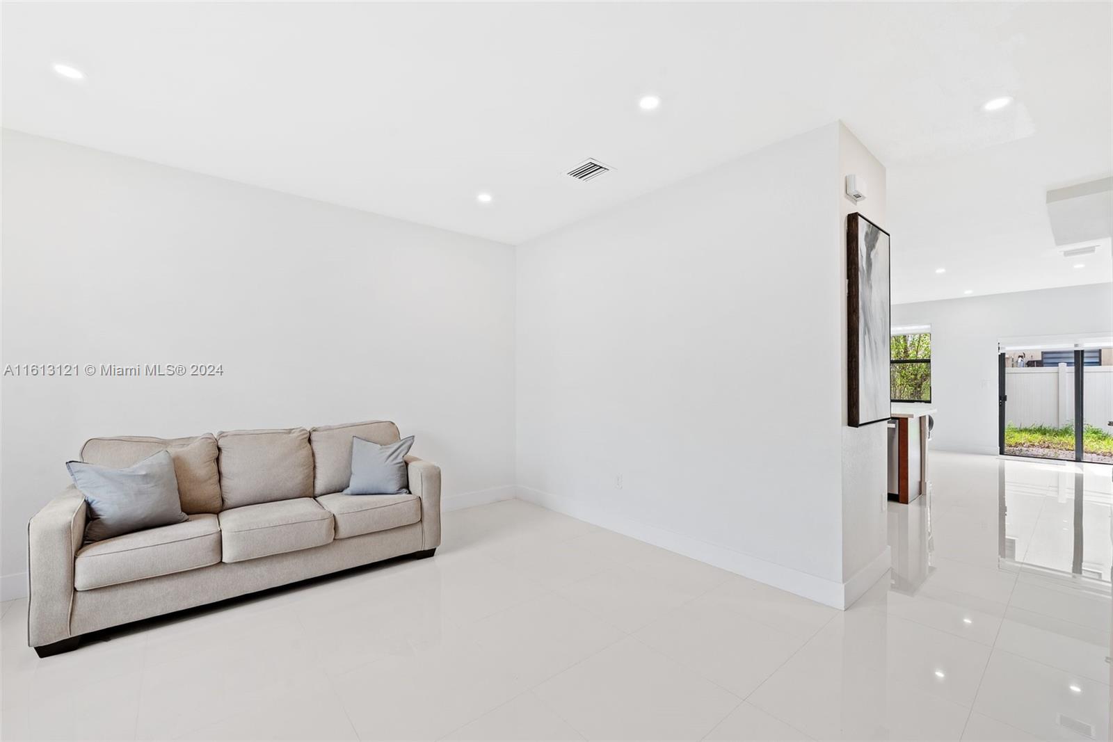 9361 West 33rd Way Hialeah, FL 33018 - Photo 4 of 30 a living room with furniture and a couch