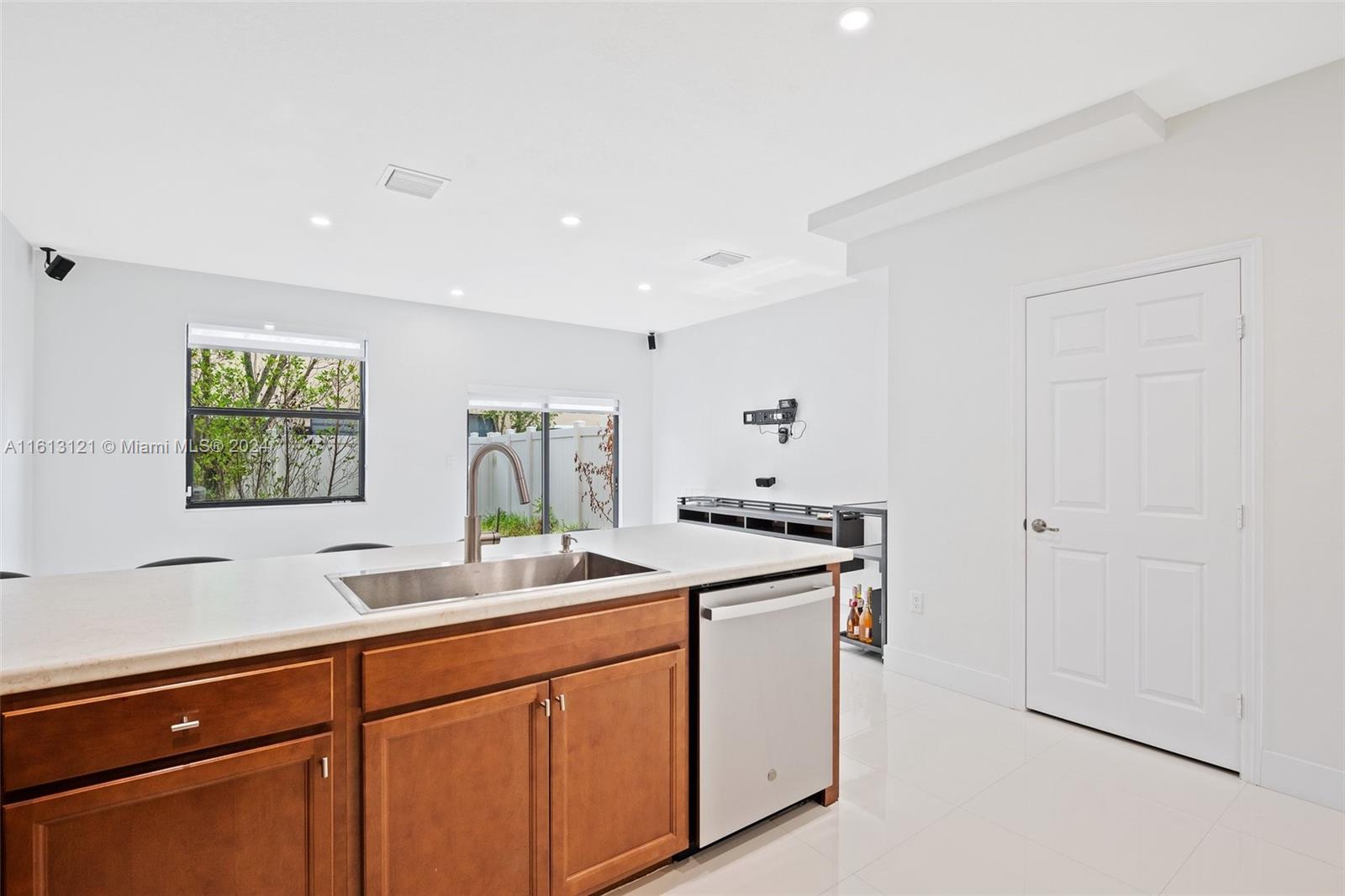 9361 West 33rd Way Hialeah, FL 33018 - Photo 7 of 30 a kitchen with stainless steel appliances granite countertop a sink and a stove with wooden floor