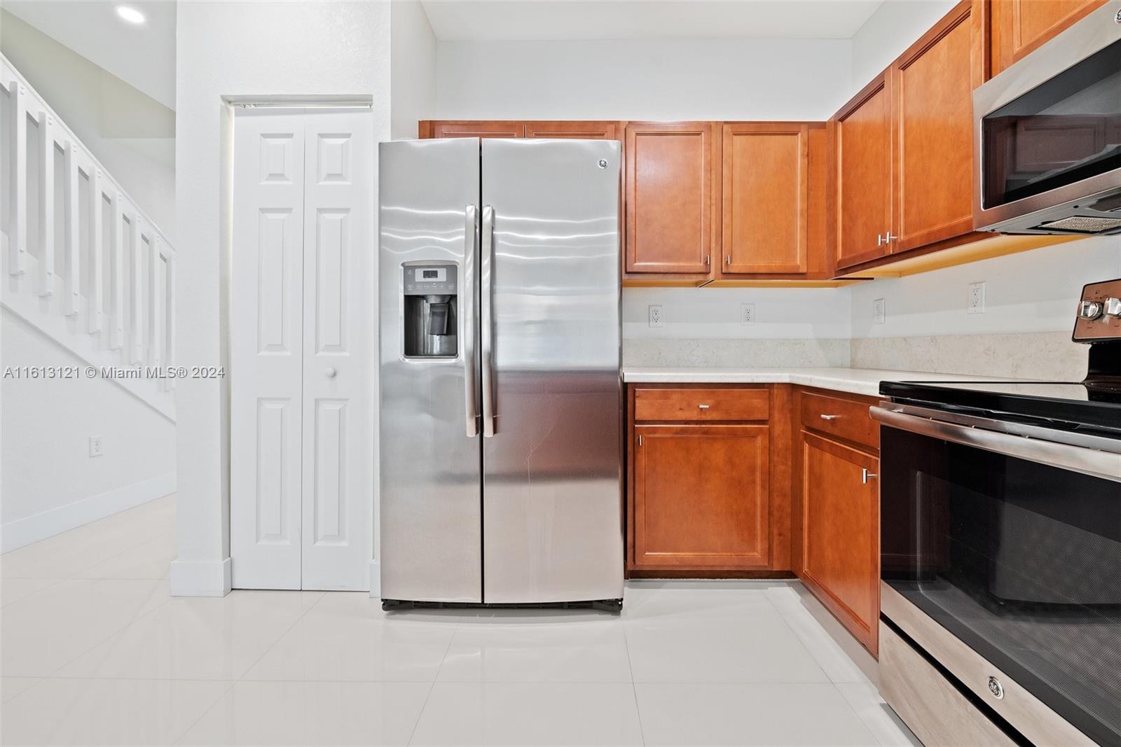 9361 West 33rd Way Hialeah, FL 33018 - Photo 10 of 30 a kitchen with stainless steel appliances granite countertop a refrigerator a stove and a microwave