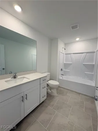a bathroom with a double vanity sink toilet and shower