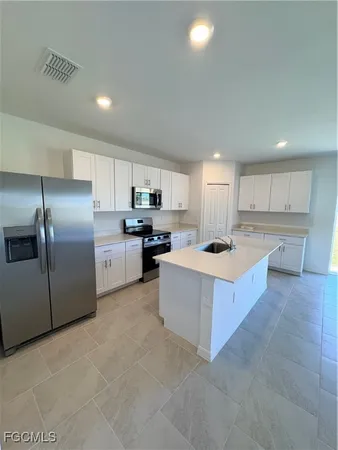 a large kitchen with stainless steel appliances lots of counter top space