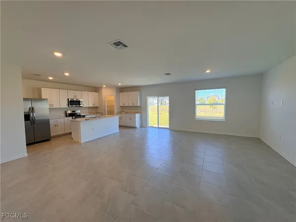 a view of a kitchen with a sink cabinets and a living room