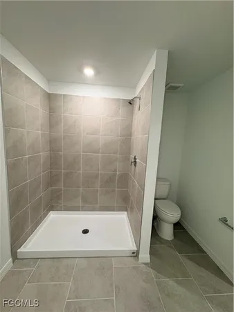 a bathroom with a shower and a toilet