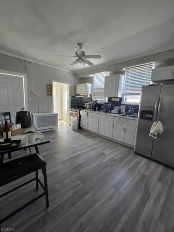 a kitchen with a refrigerator and a stove top oven