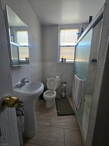 a bathroom with a sink a toilet a mirror and tub