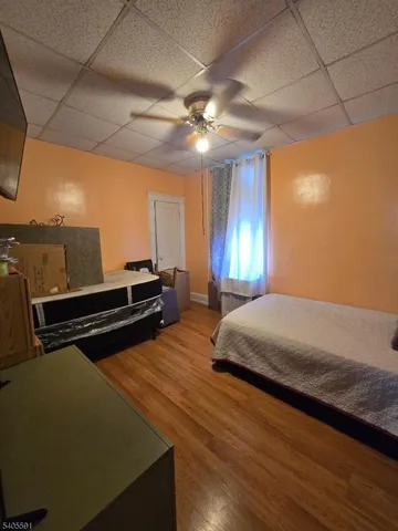 a spacious bedroom with a bed and a chandelier