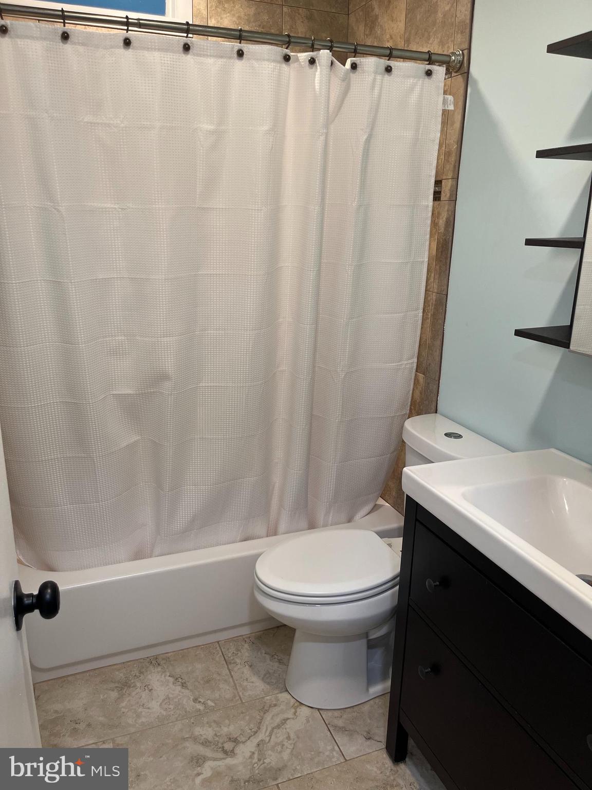 5608 Heming Avenue Springfield, VA 22151 - Photo 15 of 26 a bathroom with a toilet and a shower curtain