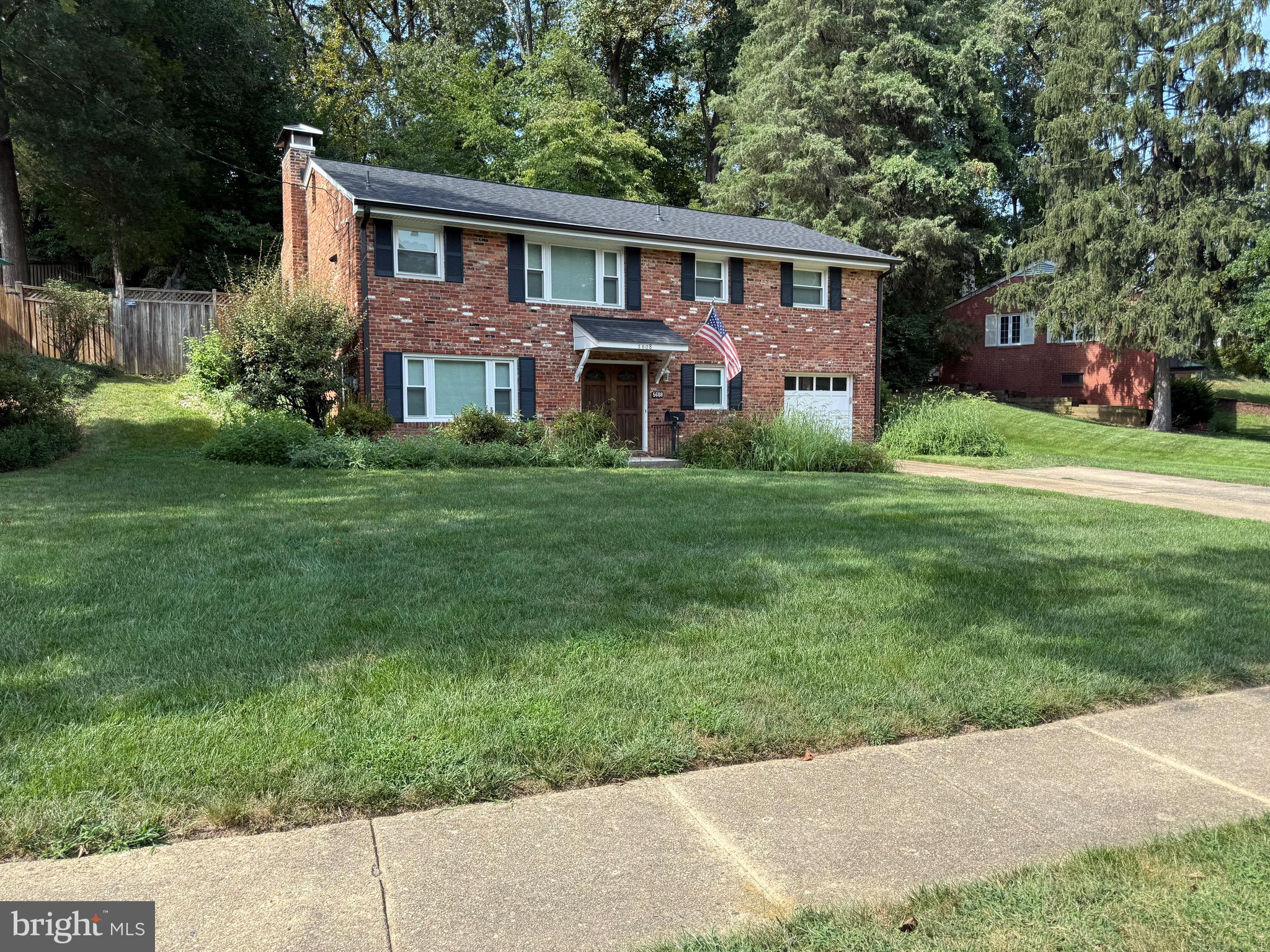 5608 Heming Avenue Springfield, VA 22151 - Photo 17 of 26 a front view of a house with a garden