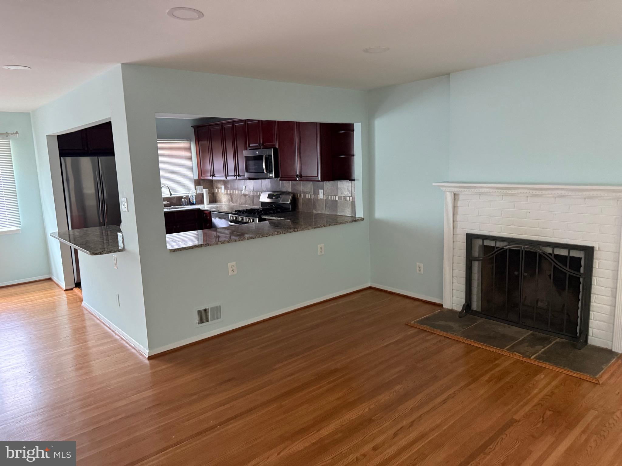 5608 Heming Avenue Springfield, VA 22151 - Photo 18 of 26 a view of a kitchen with a sink cabinets and a fireplace
