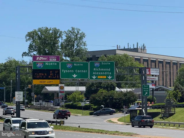 a sign board with buildings in the background
