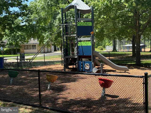 a house view with a sitting space fire pit and outdoor space