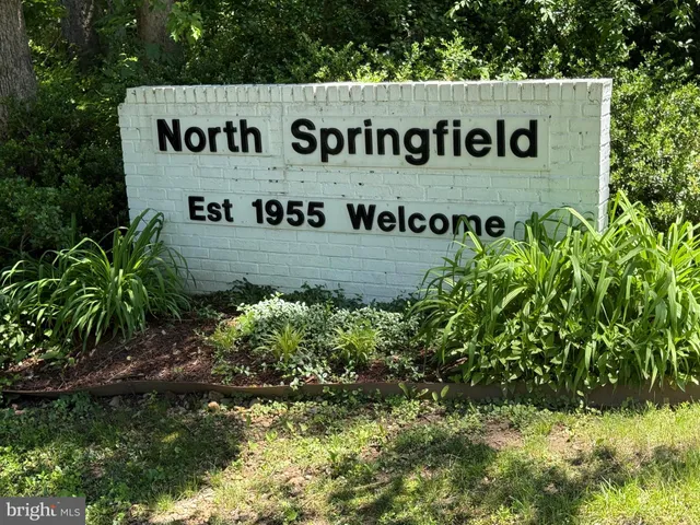 a sign broad in front of flowers