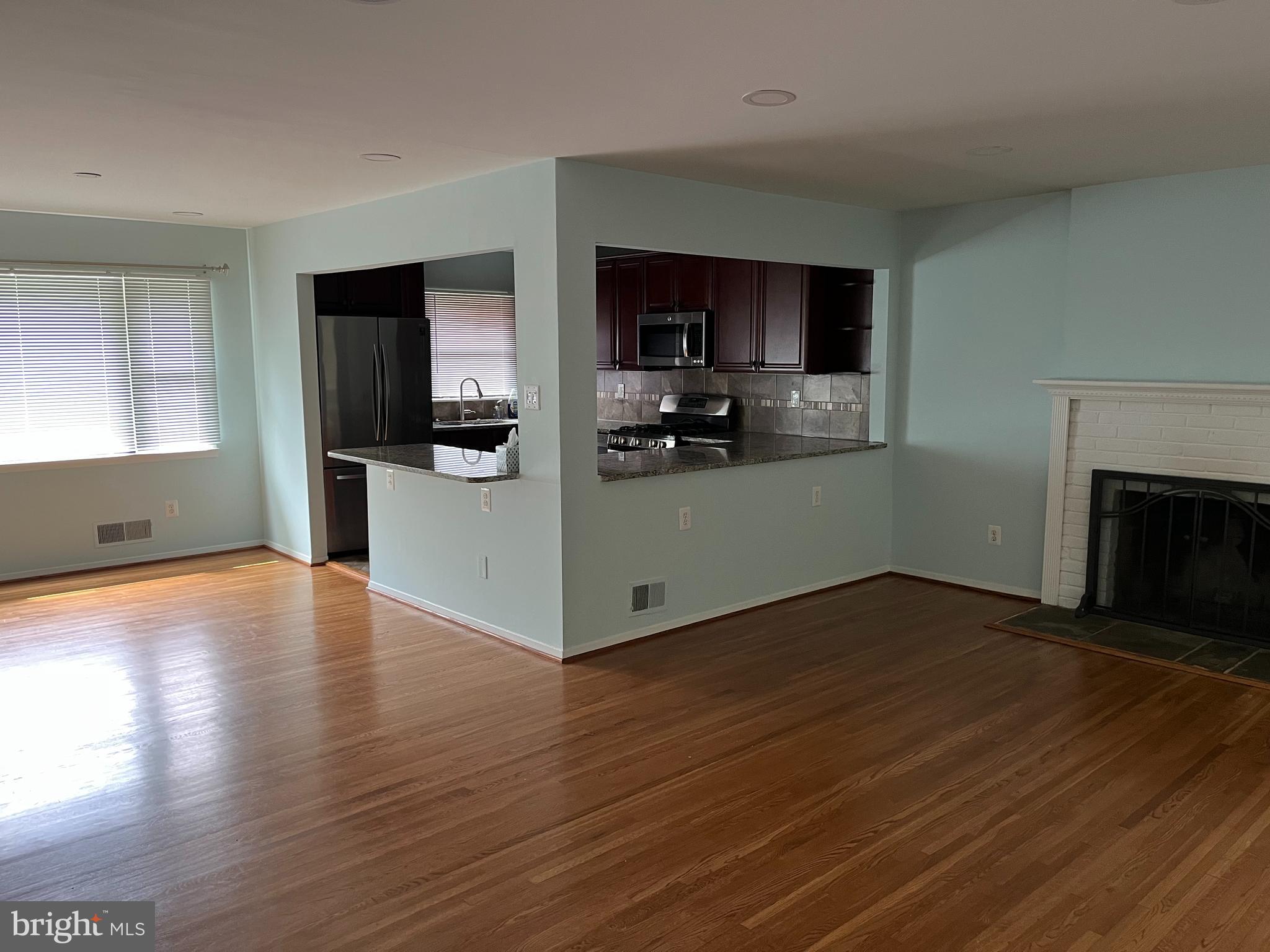 5608 Heming Avenue Springfield, VA 22151 - Photo 3 of 26 a view of a kitchen with a sink stove cabinets and empty room