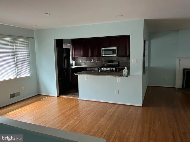a kitchen with stainless steel appliances a refrigerator sink and microwave
