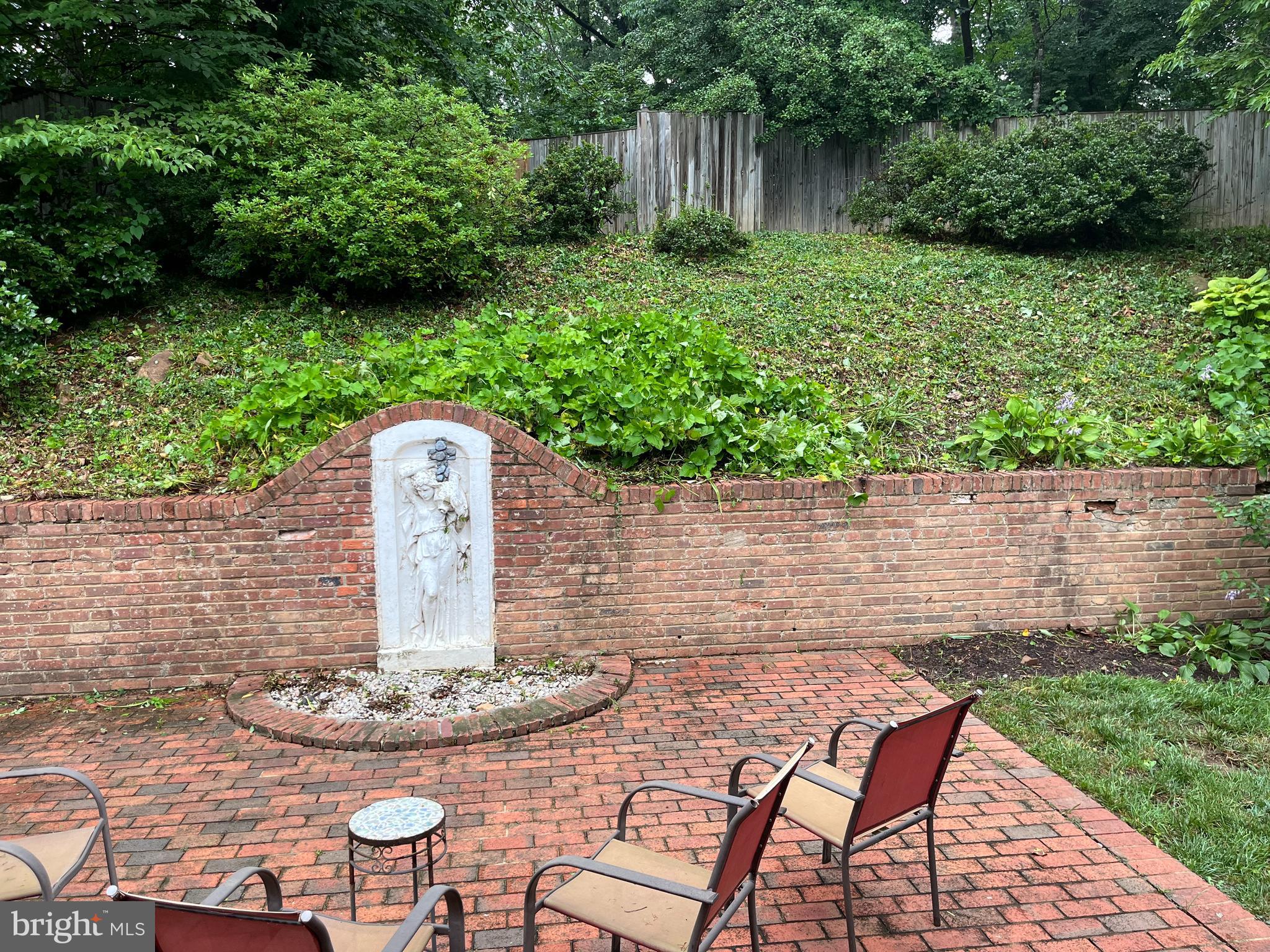 5608 Heming Avenue Springfield, VA 22151 - Photo 8 of 26 a backyard with table and chairs plants and wooden fence