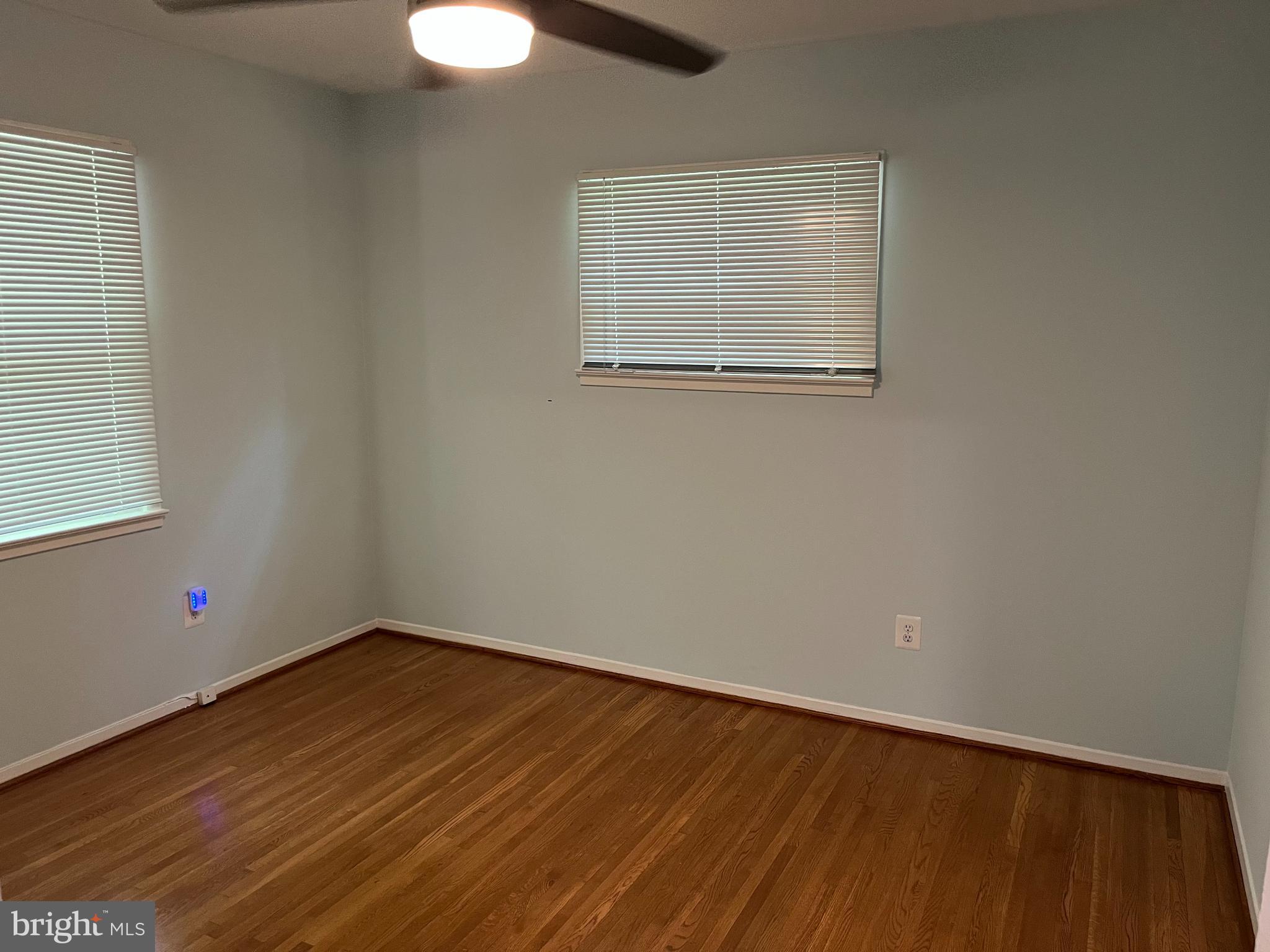 5608 Heming Avenue Springfield, VA 22151 - Photo 10 of 26 an empty room with wooden floor and windows
