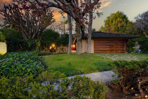 a view of a house with backyard porch and sitting area