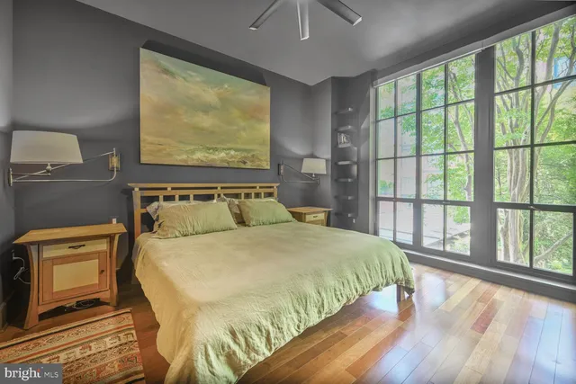 a bedroom with a large bed and a large window