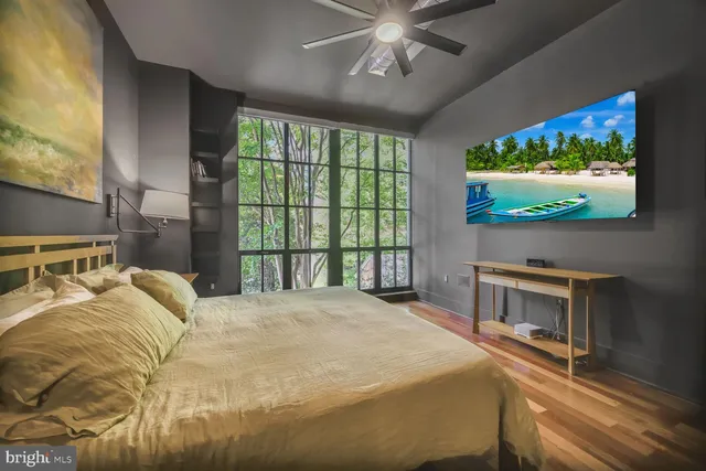 a bedroom with a bed and a flat screen tv