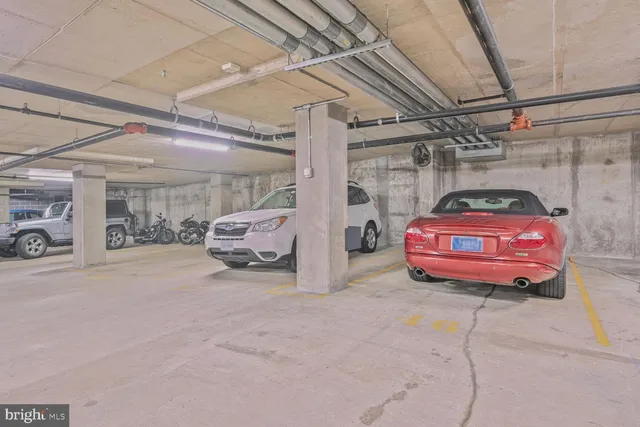 a view of parking garage with cars parked