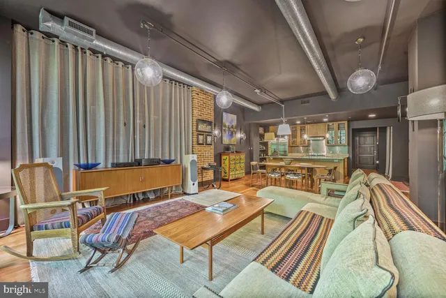 a living room with patio furniture and a large window