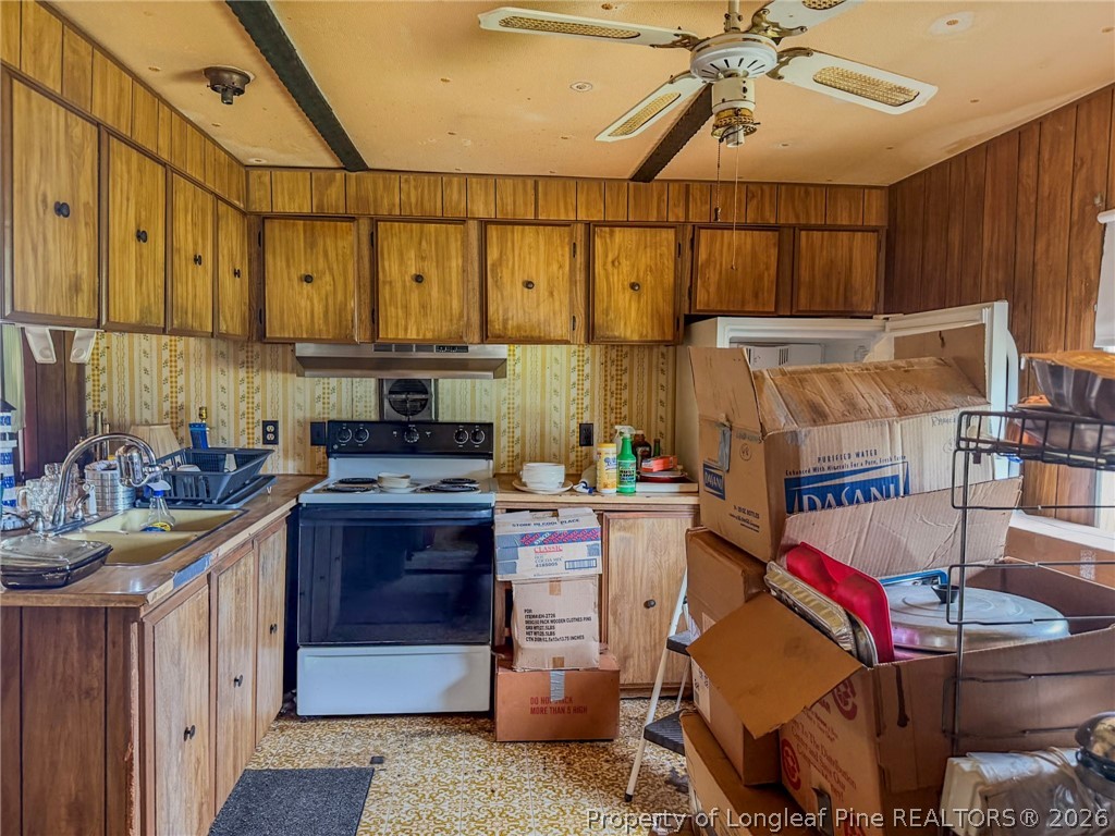 1308 Mac D Road Orrum, NC 28369 - Photo 21 of 32 a kitchen that has a lot of cabinets in it