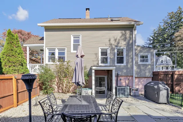 a view of a patio with table and chairs and potted plants