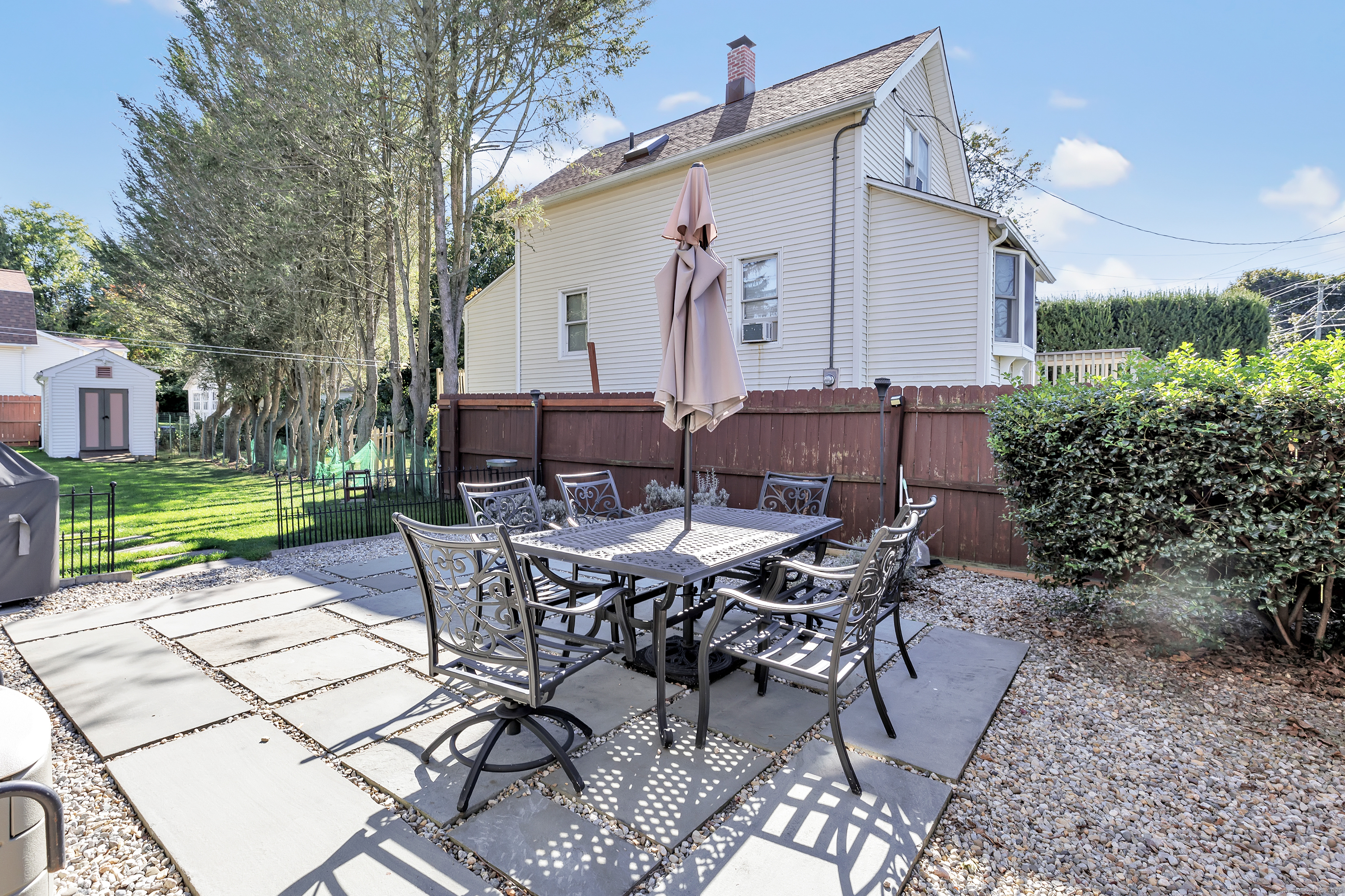 700 Huntington Road Stratford, CT 06614 - Photo 12 of 33 a view of a patio with table and chairs with plants and garden