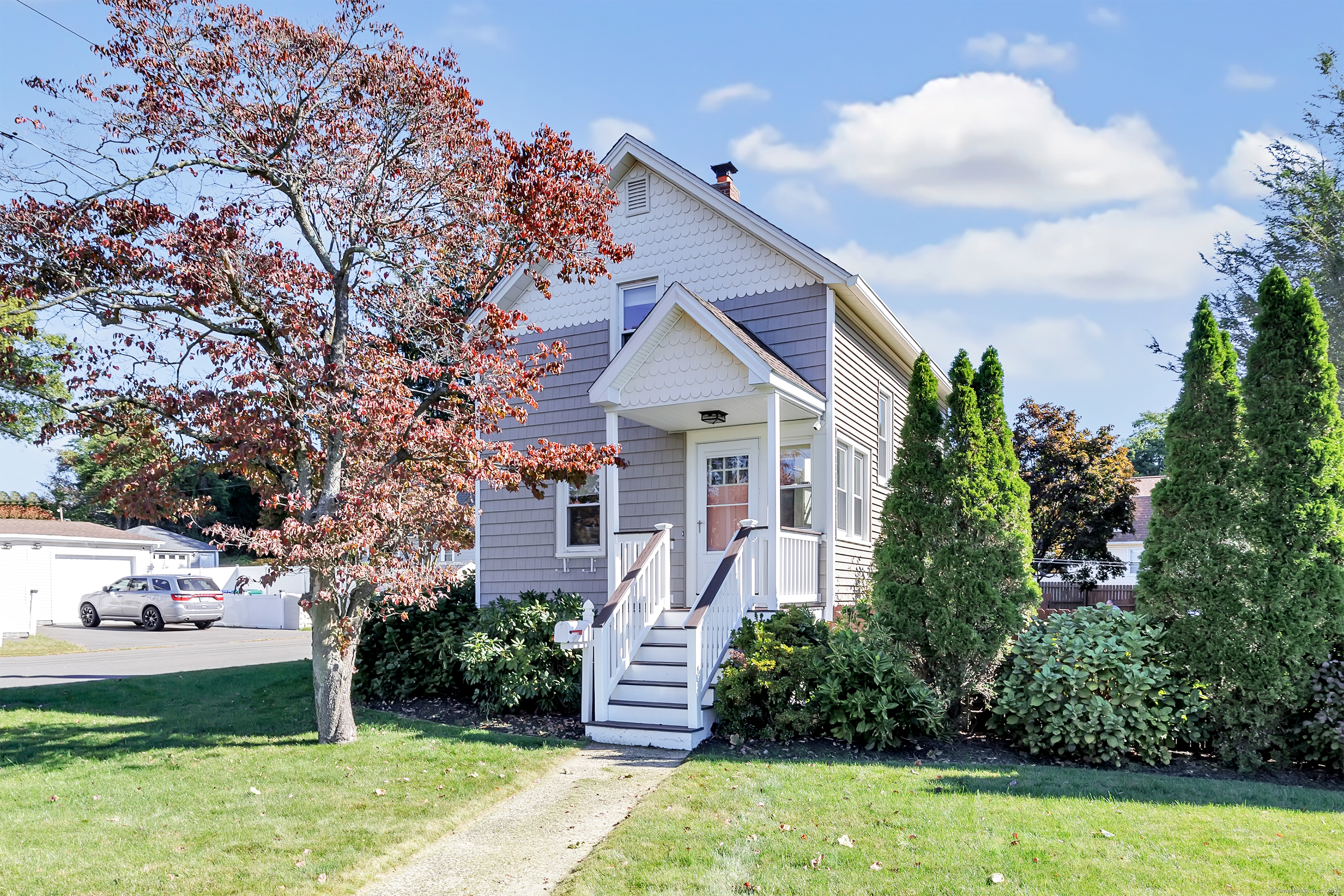 700 Huntington Road Stratford, CT 06614 - Photo 2 of 33 a front view of a house with a yard and trees