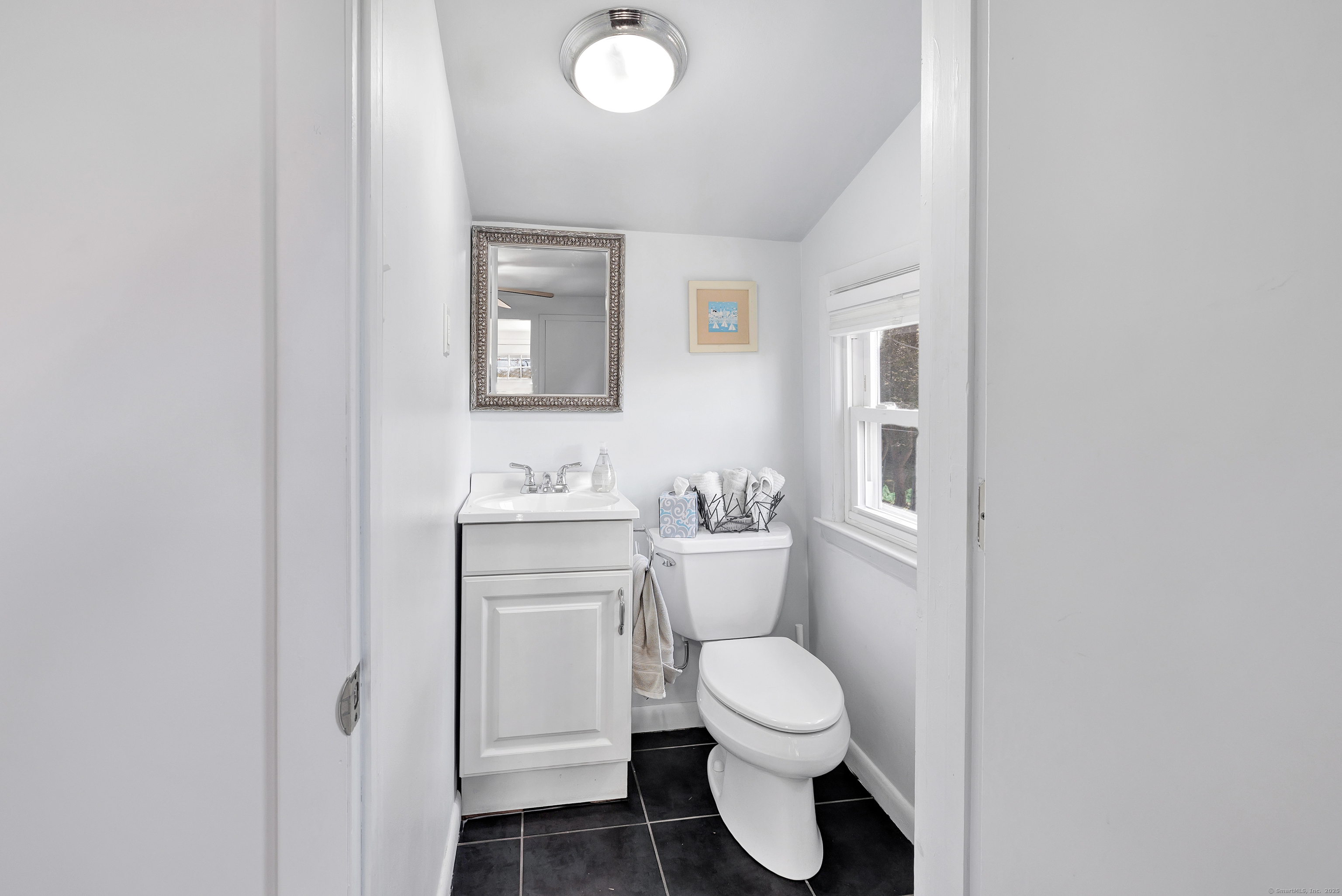 700 Huntington Road Stratford, CT 06614 - Photo 25 of 33 a bathroom with a toilet sink and a mirror
