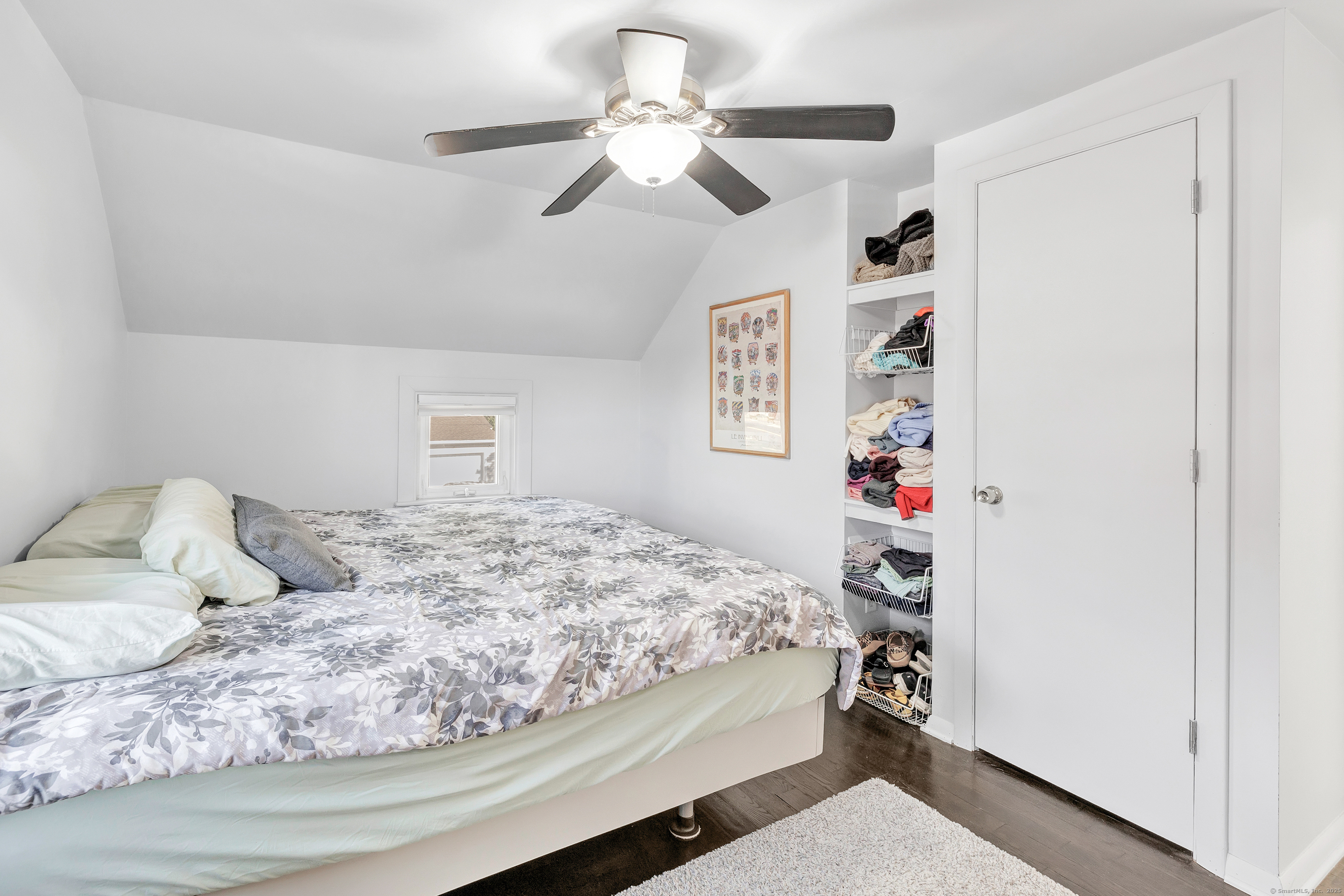 700 Huntington Road Stratford, CT 06614 - Photo 30 of 33 a bedroom with a bed and a chandelier