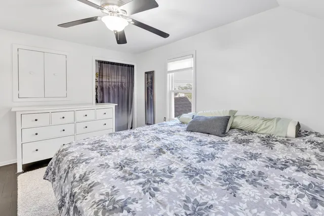 a large bedroom with a bed and a chandelier