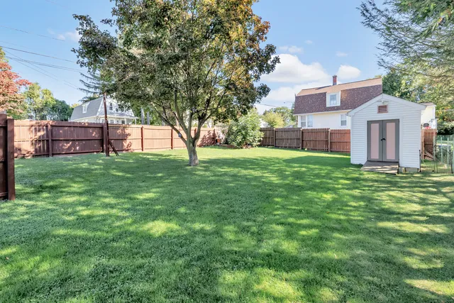 a view of a house with a yard and sitting area