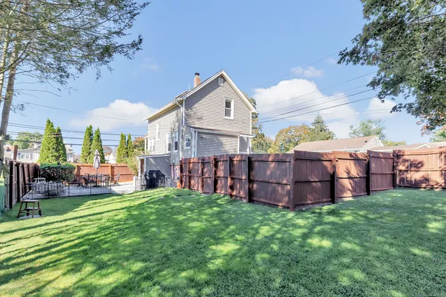 a view of a house with a yard and sitting area