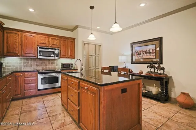 a kitchen with stainless steel appliances granite countertop a stove and a sink