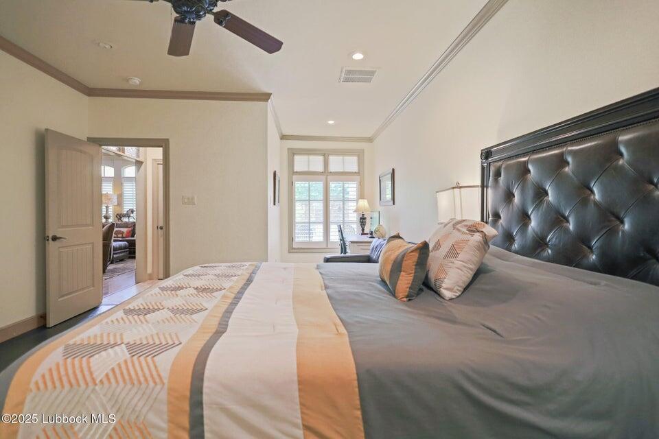 4501 19th Street, Unit 6 Lubbock, TX 79407 - Photo 17 of 44 a spacious bedroom with a large bed and a chandelier