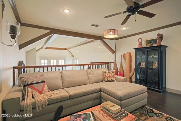 a bedroom with furniture and a ceiling fan